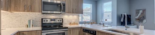 a kitchen with wooden cabinets and stainless steel appliances