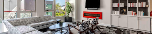 a living room with couches and chairs and a television