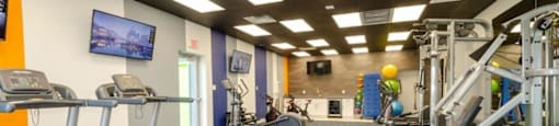 a gym with treadmills and other exercise equipment