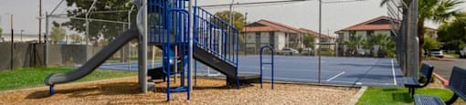Apartments for Rent in Mesa, AZ - Mesa Station - Large Playground with Slide and Bench Seating