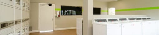 a room filled with lots of white washers and dryers