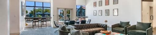 a living room filled with furniture and a large window