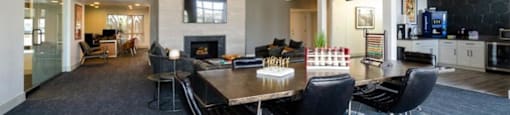 a large room with a table and chairs and a fireplace