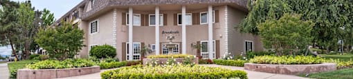 Fremont, CA Apartment for Rent - Brookvale Chateau - Exterior of Complex Building with Flowers, Driveway, and Trees