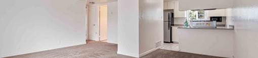 Dog-Friendly Apartments in Fremont, CA - Brookvale Chateau - Living Room with Carpeting, High Bar Countertop, and Open Layout