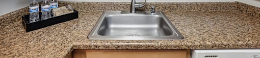 a kitchen with a sink and wooden cabinets