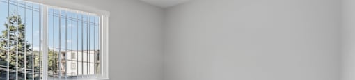 an empty room with carpet and a window