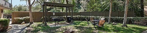 a backyard with a picnic table and a bench