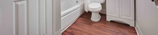 a bathroom with a toilet and a tub and a sink