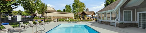 A large outdoor swimming pool with a blue bottom and white bottom edge.