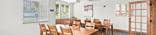 A conference room with a long table and chairs.