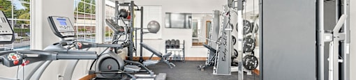 Apartments in Spokane, WA, with In-Unit Washer and Dryer - Deer Creek Apartments - Fitness Center With Strength Training Machines and Large Wall Mirrors.