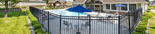 A house with a pool and a fence.