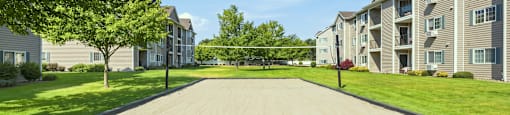 A large grassy area in front of apartment buildings.