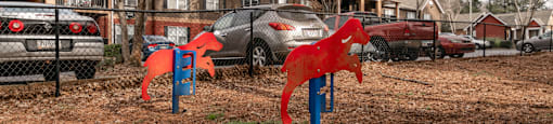 Fenced pet park with agility equipment at Flats at River View apartments in Duluth, GA, near Lawrenceville.