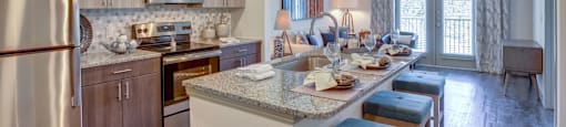Georgetown Apartments for Rent - Williamson at The Overlook - Kitchen with Stainless-Steel Appliances, Kitchen Island, and Granite-Style Countertops