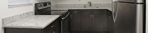 39th Avenue apartments in Gainesville, FL photo of kitchen with wood-style flooring