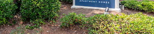 Community entrance sign at Flats at River View apartments in Duluth, GA, near Lawrenceville.