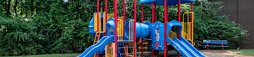 Community playground with safe play structures at Flats at River View apartments in Duluth, GA, near Lawrenceville.