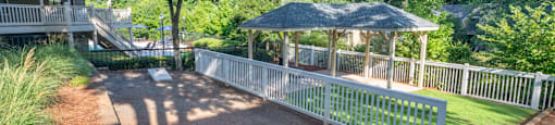 Outdoor recreational area with cornhole game at Forest Glen apartments in Austell, GA 30106, near South Cobb County and Douglasville