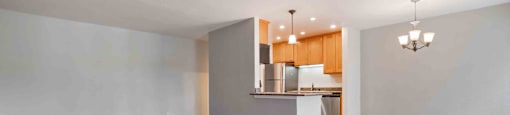 Two Bedroom Apartments in Santa Clara, CA - Hidden Lake - Open-Concept Living Area with Wood-Style Flooring, Grey Walls, and Dining Area.