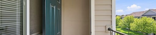 A blue door is on the left side of a white wall.
