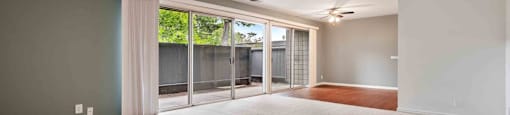 Apartments for Rent Fremont CA - Logan Park - Huge Empty Living Room with Carpet and Sliding Glass Door to Patio