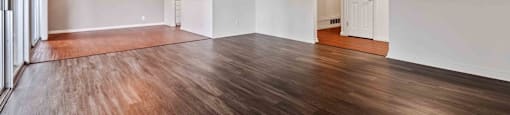 Two-Bedroom Apartments in Fremont, CA - Logan Park - Spacious Living Room with Sliding Glass Doors to Patio/Balcony, a Ceiling Fan, and Wood-Style Flooring.