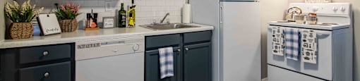 Mableton Ridge Dark Cabinetry, Cozy Kitchen, with white appliances.