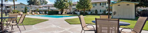 Gilroy Apartments for Rent - Mission Park - Outdoor Lounge Area With Seating, Tables, and Umbrellas Near the Swimming Pool