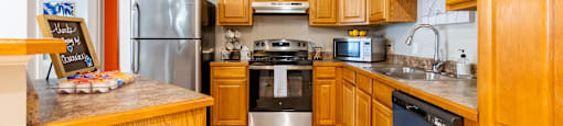 A kitchen with wooden cabinets and a sign that says beach.