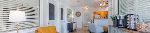 A living room with a yellow chair and a grey cabinet.