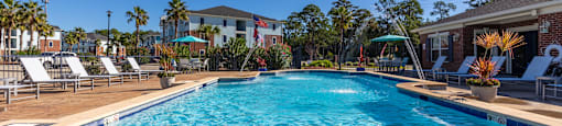 A large swimming pool with a blue tiled edge and a white tiled edge.