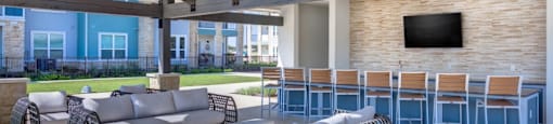 Apartments for Rent in Georgetown - Williamson at the Overlook Apartments - outdoor sitting area with tv