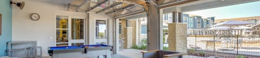 Apartments Georgetown - Williamson at the Overlook Lounge with Pool Table, Comfortable Seating, and View of Swimming Pool