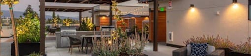 a modern patio with furniture and a roof