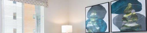 2-Bedroom Apartments in Santa Clara, CA- Santana Terrace - Furnished Living Room with Wood-Style Flooring, a Ceiling Fan, and a Window with Blinds