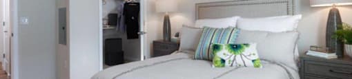 Apartments Santa Clara, CA - Santana Terrace - Bedroom with a Spacious Closet, Plush Carpeting, Two Nightstands, and a Queen-Size Bed