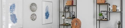 2-Bedroom Apartments in Beaverton, OR - Westline - Home Office with Vinyl Hardwood Flooring, Area Rug, Desk, Chairs, Wall Art, and Display Shelves.