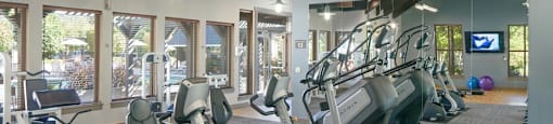 A gym with treadmills and exercise bikes.
