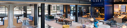 A large open space with a lot of furniture and a patterned rug inside The Laura community lounge.