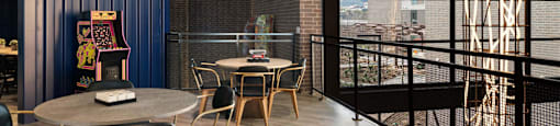 A modern sitting area with a round table and chairs.