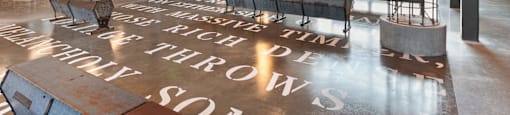 A large open room inside The Laura office with a floor that has a quote on it.