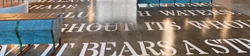 A large open room inside The Laura office with a floor that has a quote on it.