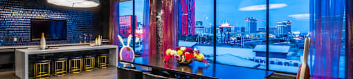A modern dining room with a view of the city.