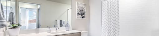 a bathroom with a large mirror and a toilet next to a bathtub