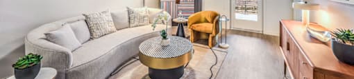 a living room with a gray couch and a yellow chair