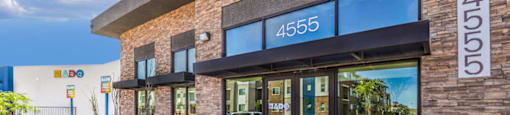 a brick building with glass doors and a black awning with the number 4550 on