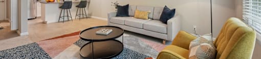 a living room with a couch and a chair and a ceiling fan