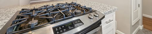 a kitchen with a stove top oven and a microwave